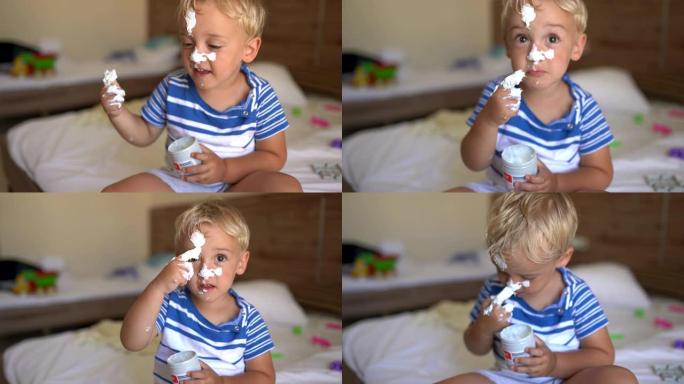 可爱的小男孩在鼻子上涂上面霜。