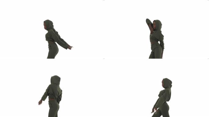 穿着连帽运动服跳舞的非洲妇女的侧视图。舞者通过向后扭转手臂来展示超强的肩部灵活性。表演街舞。孤立在白