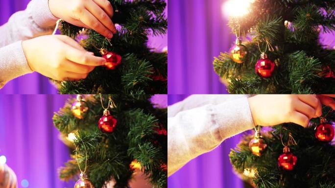 孩子在家用手装饰松树上的圣诞装饰品。
