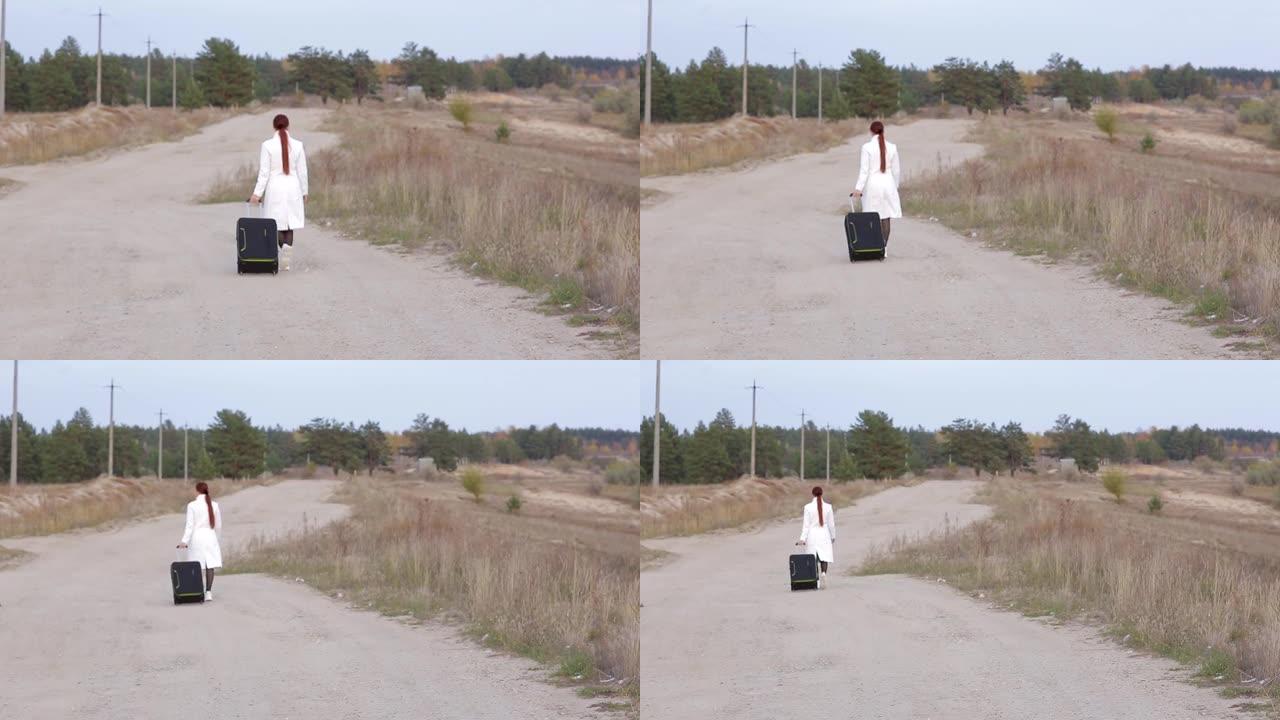 一个带着手提箱的孤独女人在没有蜂窝连接的空旷道路上行走，试图捕捉电话信号。