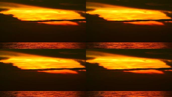 黑金日落剪影在海上傍晚的天空中橙色云的硬光