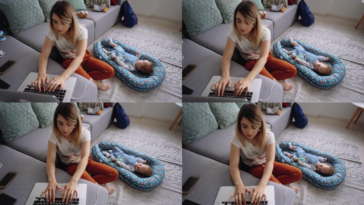 年轻的单身母亲在家工作，男婴躺在她旁边