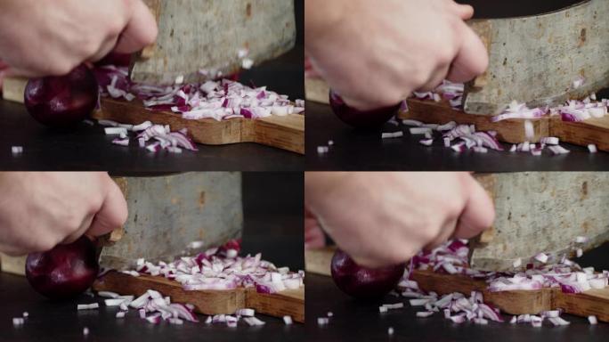 男人的手将红洋葱切成小块的大刀。
