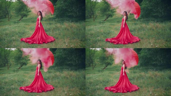 穿着红色连衣裙的美女，手里拿着雨伞。女王在森林里摆姿势