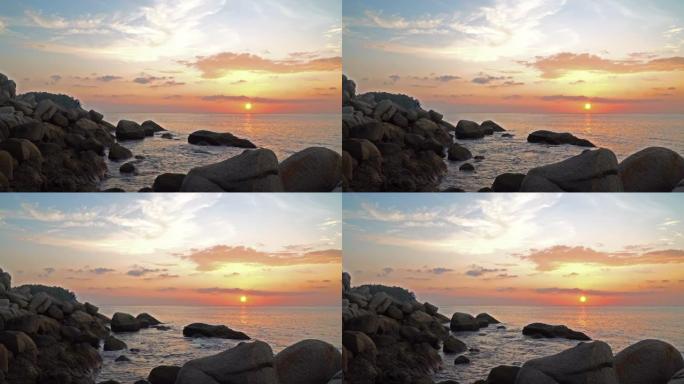 日落时岩石上方的平滑波浪