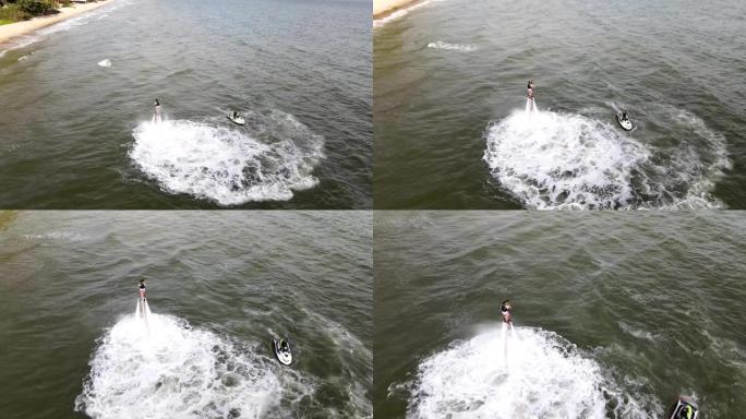 男子在水上极限运动飞板上摆姿势的鸟瞰图。