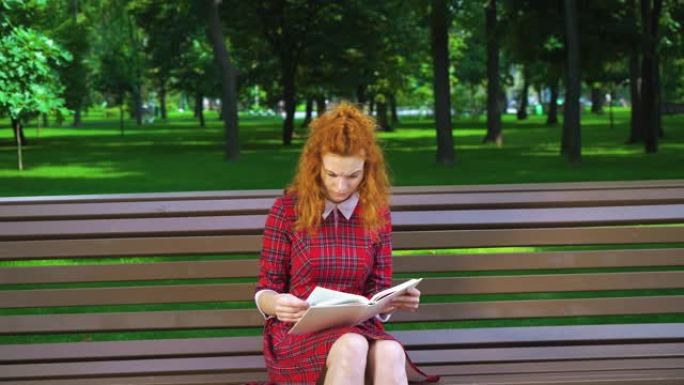 不快乐的女孩在公园看书，皱着眉头