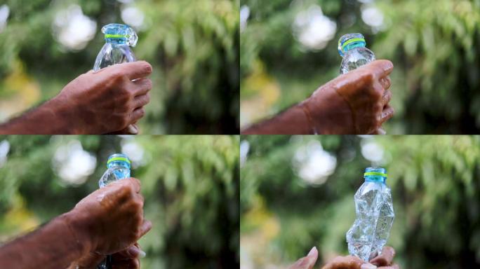 在丢弃垃圾之前，用手挤压塑料水瓶。