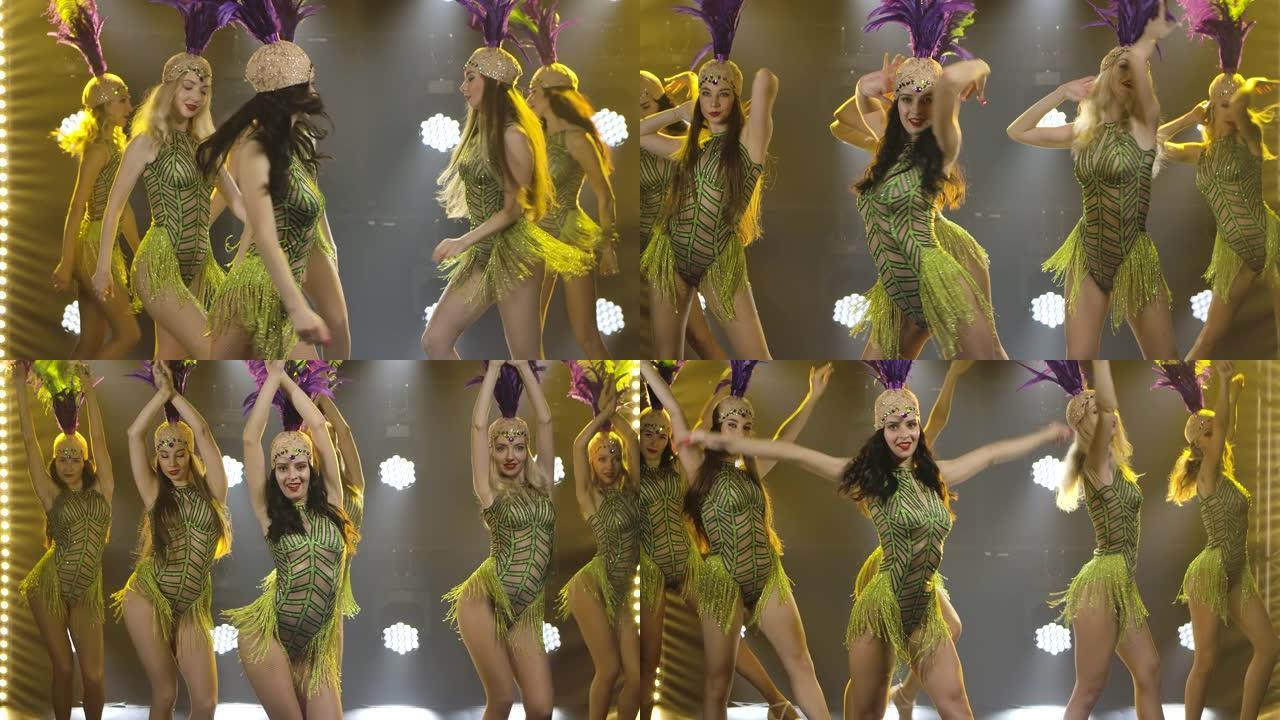 漂亮女团在黑暗舞台上的舞蹈表演，黄色灯光特写。穿着高跟鞋的女性慢动作的团队舞蹈