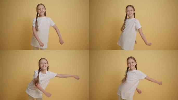 黑发小女孩在黄色墙壁背景慢动作中跳舞