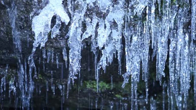 冰柱和流动水融化的冰锥流水户外冰冻