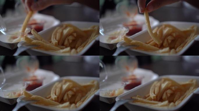 人们吃垃圾食品薯条蘸番茄酱的4k视频。