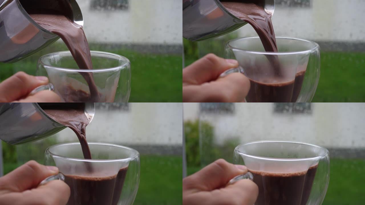 在下雨天，将钢水罐中的热巧克力倒入玻璃杯中