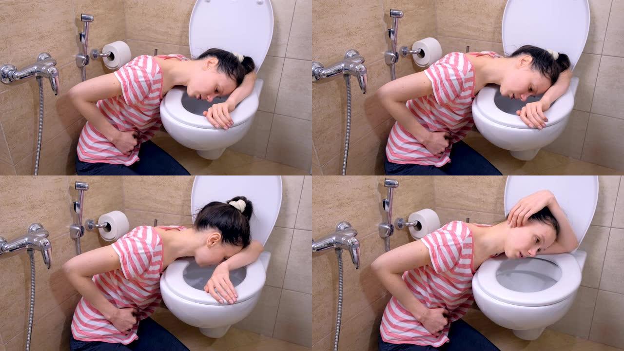 生病的年轻女子肚子痛是在厕所里呕吐坐在家里的地板上，食物中毒的症状。