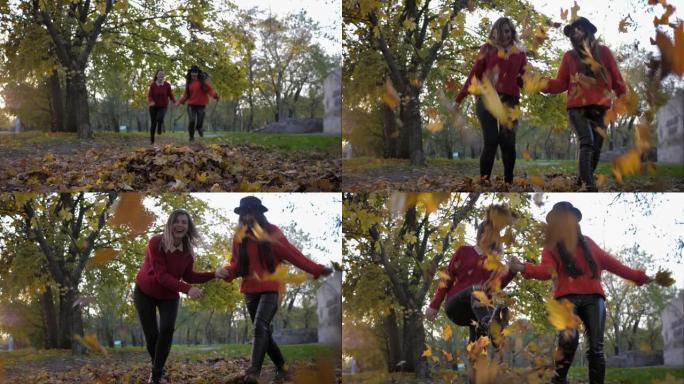秋天的娱乐，迷人开朗的女性朋友在秋天的秋天公园散步时，牵着手奔跑，蔓延着落叶的脚