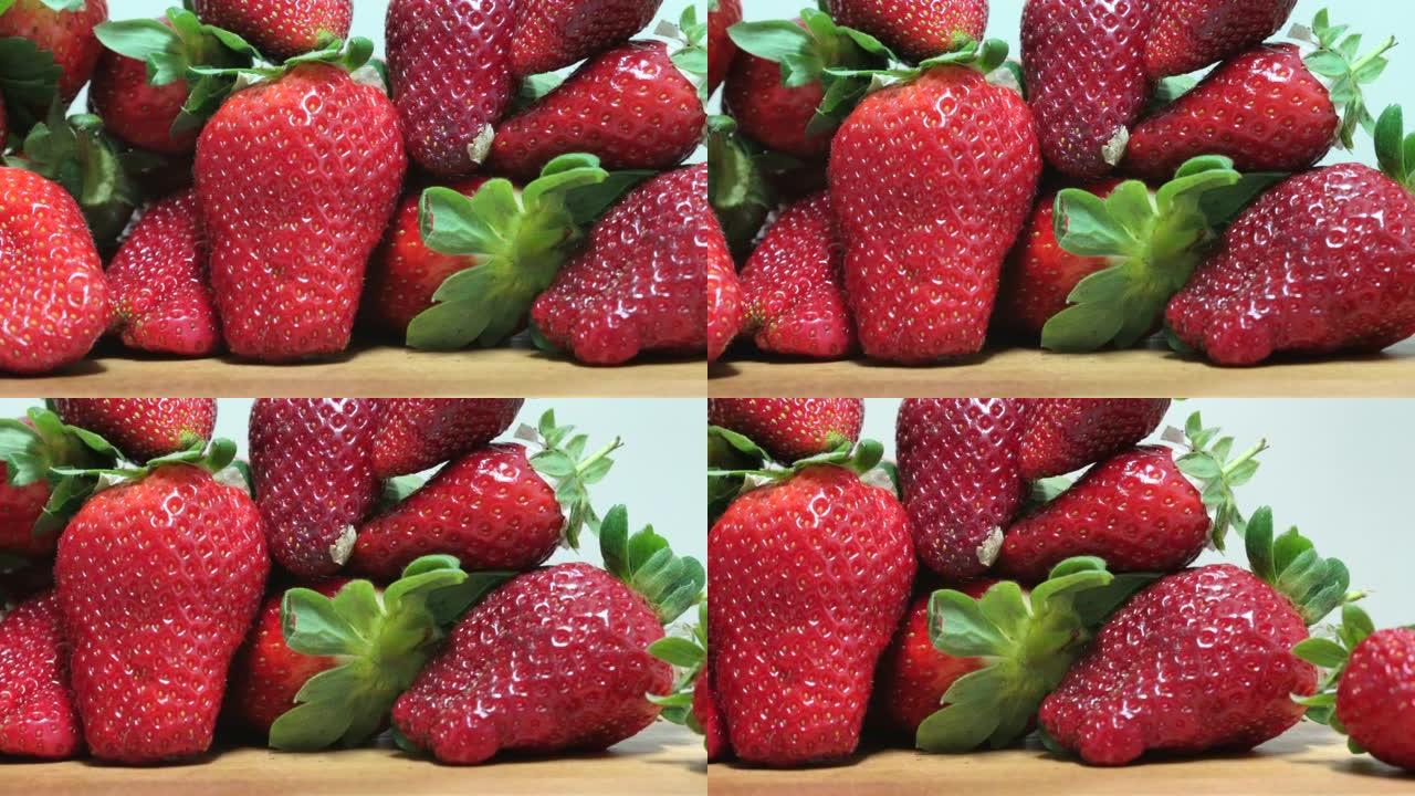 美丽甜美成熟的红色草莓，红色的夏季浆果，特写，健康的浆果饮食。新鲜收获的草莓背景。UHD, 4K