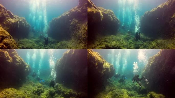 一群潜水员在大西洋火山起源底部水下。