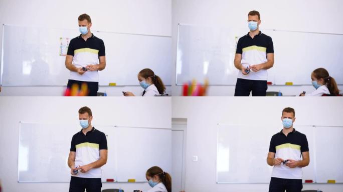 带口罩的老师激励孩子在冠状病毒后活跃在教室里