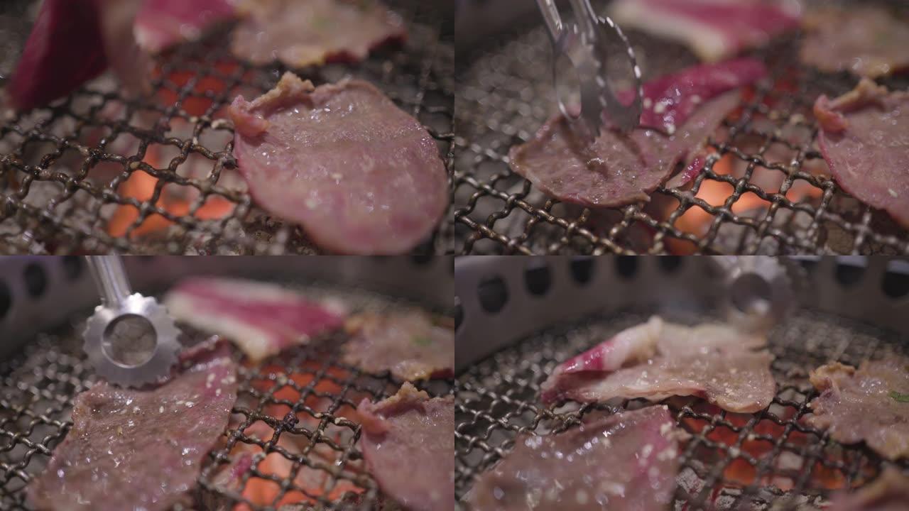 4k极端特写烹饪钳在烧烤架上烤牛肉片，做得很好，韩国餐厅，火焰烤，主菜，沙朗，里脊肉，和牛，烤肉风格
