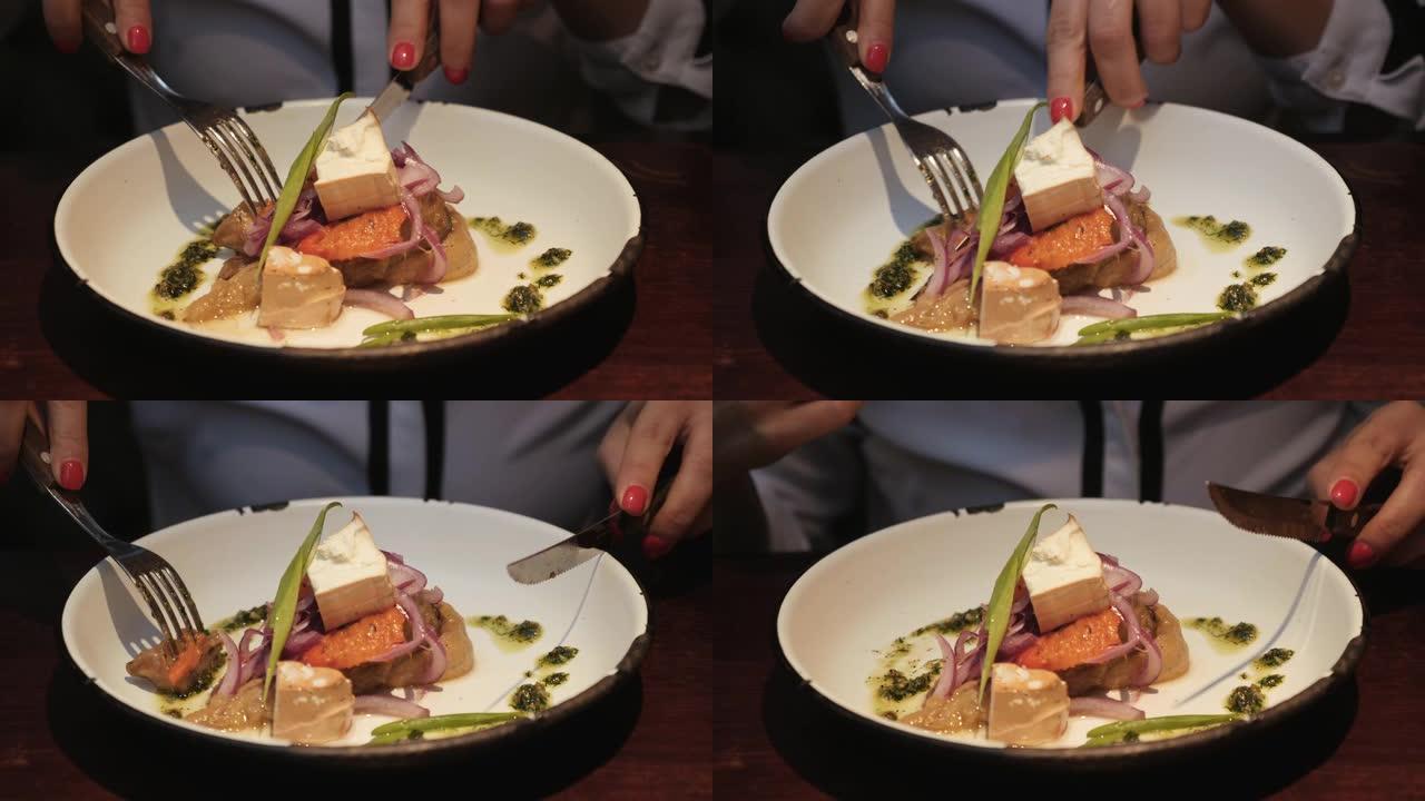 素食沙拉的特写视图。女人用刀叉吃蔬菜沙拉。