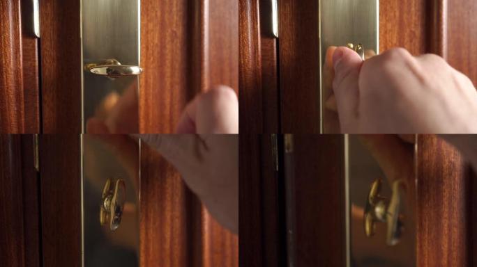手转动并解锁青铜金门插销锁并打开门。