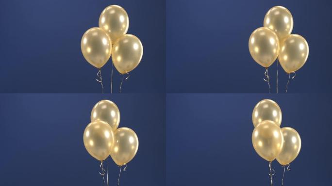 装饰元素-三个金色气球-悬停在滚筒中，作为节日的礼物: 情人节，生日，圣诞节或新年在蓝色背景上。