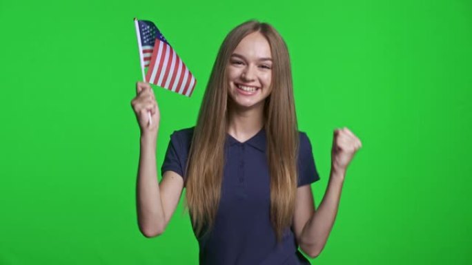 快乐的女孩举着小美国国旗庆祝胜利