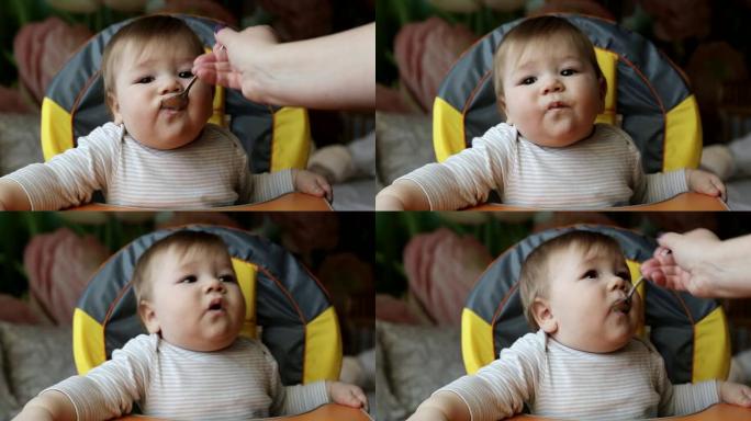 用勺子喂小帅哥粥，特写。一岁左右儿童营养，背景，高加索人