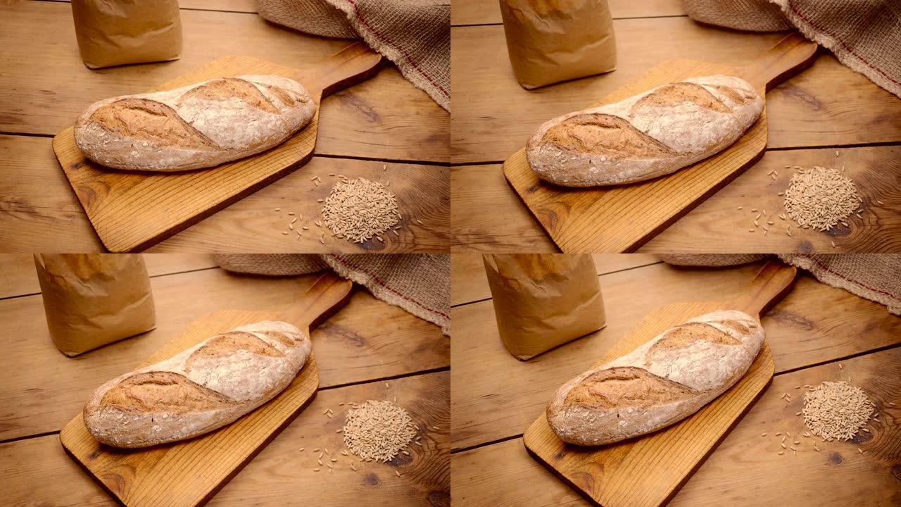 美味的自制黑麦面包从桌子上方射出，上面放着黑麦谷物
