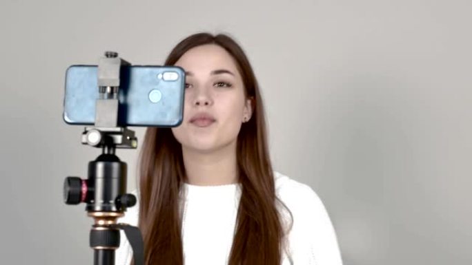 高加索女孩博客作者站在手机摄像头前，进行录像