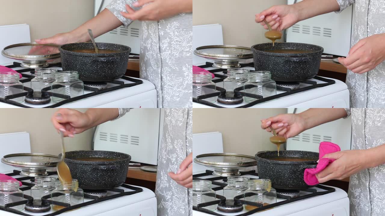 那个女人正在做苹果果酱。用勺子在平底锅里搅拌。玻璃罐里的地方。