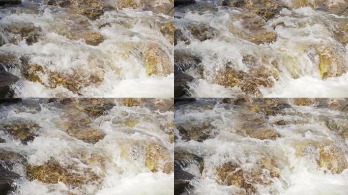 水流过岩石，在春江中形成白浪，特写细节，慢动作镜头