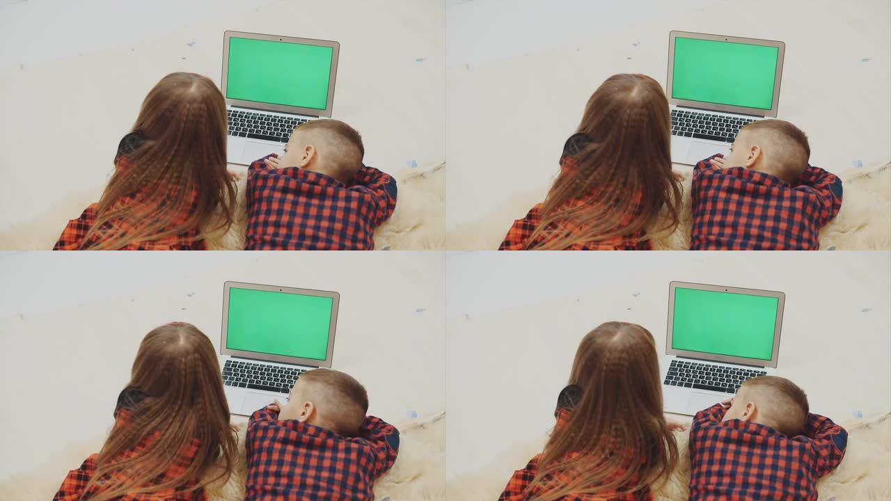 上看4k视频，可爱的孩子看着带有复制空间的笔记本电脑，以获取图像，文本或其他内容。