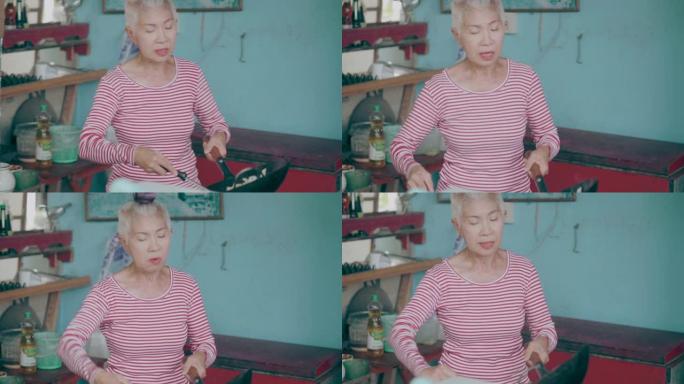 东南亚高级女性正在为她的家人烹饪她的特别菜单-股票视频