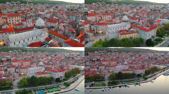 空中无人机观看克罗地亚亚得里亚海历史名城西贝尼克老城和圣詹姆斯大教堂的日落场景