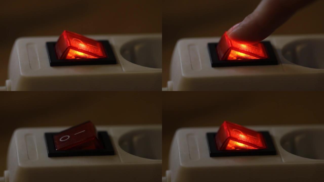 女性手指按下红色开/关电源按钮。特写视频，选择性聚焦