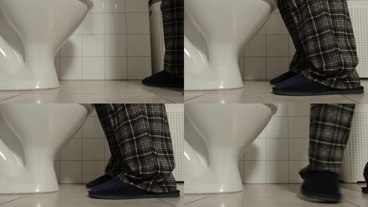 穿着睡衣和拖鞋的男性腿上厕所