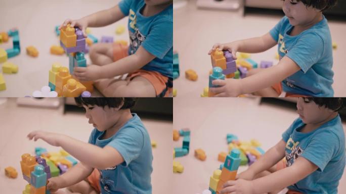 亚洲男孩玩塑料块玩具