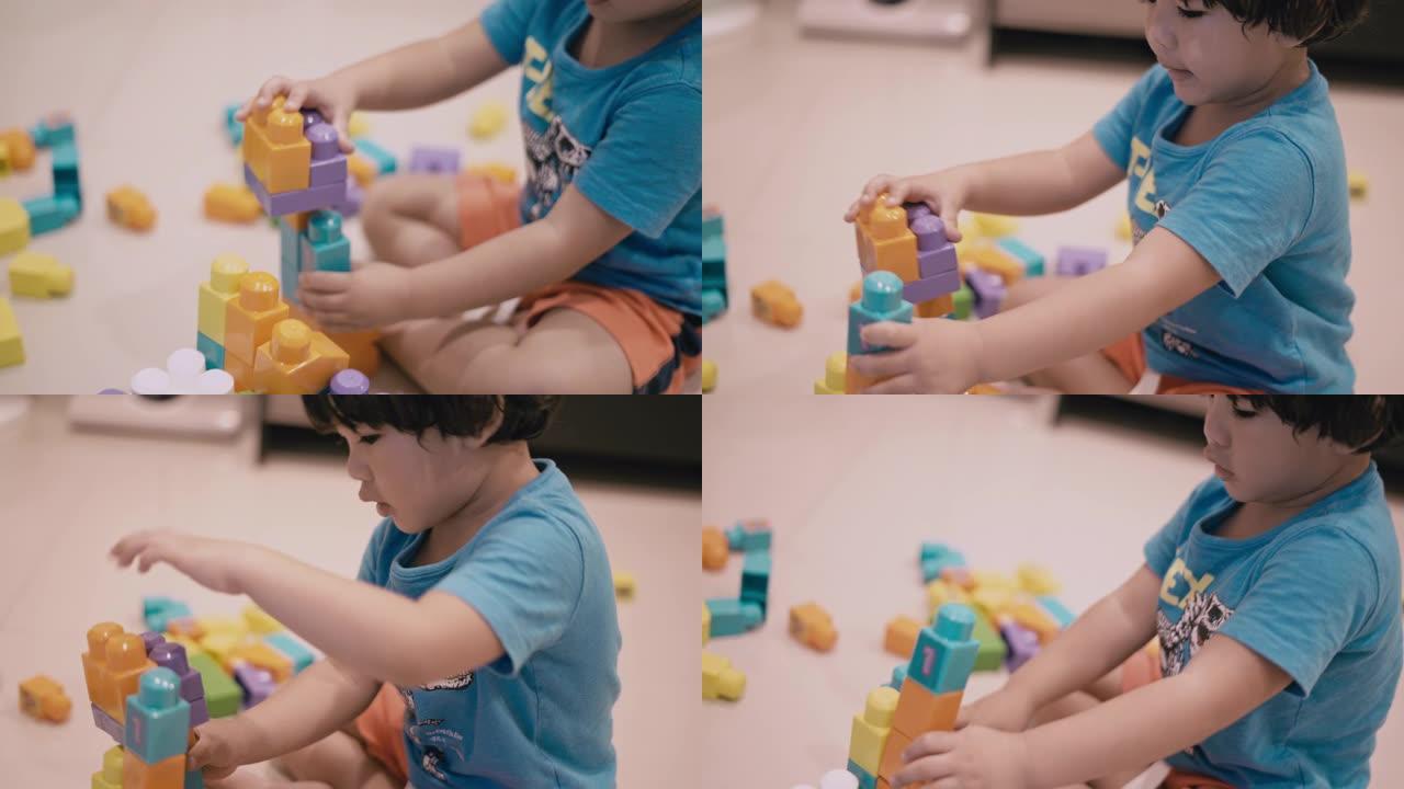 亚洲男孩玩塑料块玩具