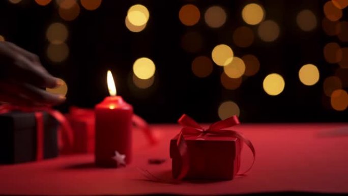 蜡烛和红色礼品盒在特殊的浪漫日子和bokeh