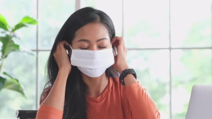 特写亚洲年轻女子戴着防护口罩防止病毒，防止空气中感染，冠状病毒概念，4k分辨率，慢动作