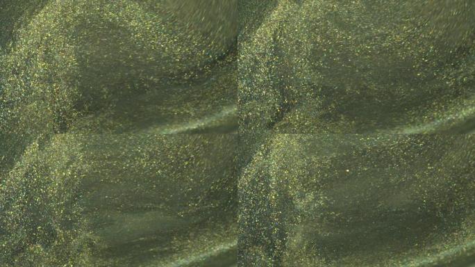 橄榄绿色和黑色金色亮片。闪光丙烯酸涂料流动。液体闪光纹理。闪亮的背景