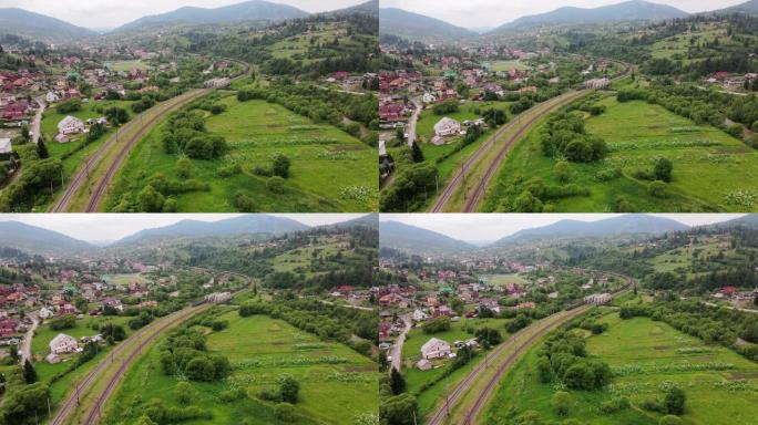 货运列车在森林喀尔巴阡山脉通过铁路运送电力机车。空中摄影无人机在夏天的视野。