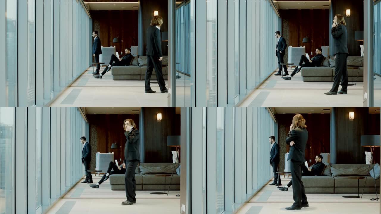 三个穿着黑色西装的男人在现代餐厅的全景窗户前。4K
