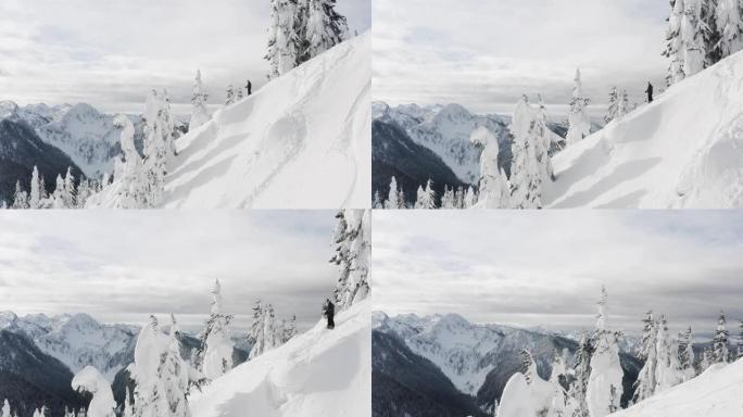 雪山山顶上的滑雪者俯视滑雪坡空中无人机飞过