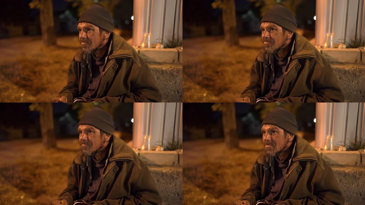 晚上街上孤独寒冷的无家可归者的脸。