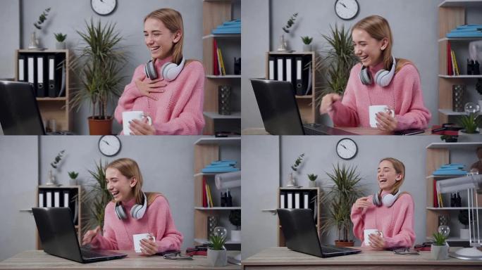 穿着时髦毛衣的华丽快乐女孩的慢动作，重温电脑上有趣的视频，全心全意地笑