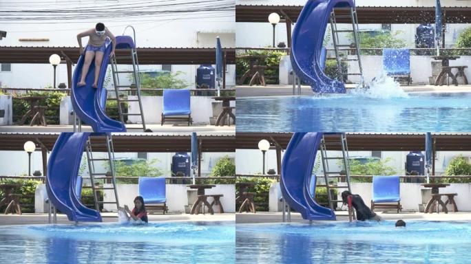 快乐的亚洲儿童玩水滑块，摔倒在游泳池上。