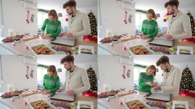 年轻的高加索爱情夫妇一起烤圣诞饼干