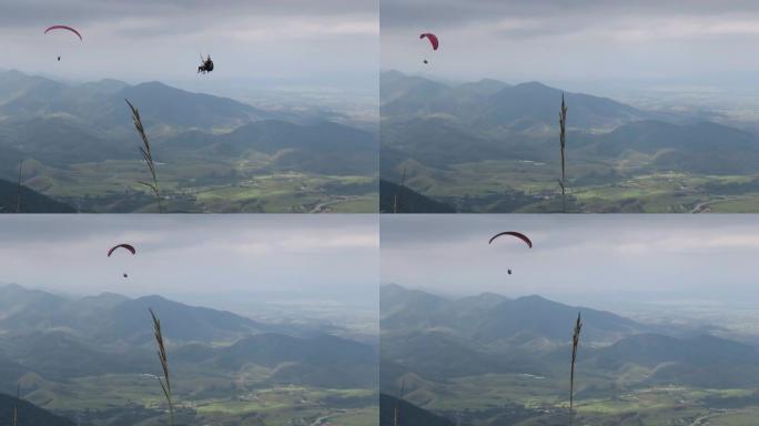 阴天滑翔伞在山上飞行